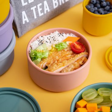 A fruit box in a refrigerator with a large size. A tupperware container in a household sealed container