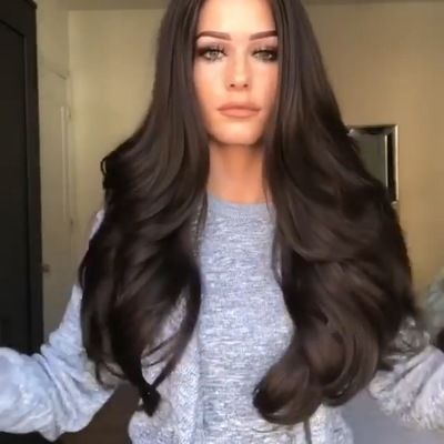 The new wig for women in Europe and America features a long, middle-parted curly hair that is naturally black and fluffy