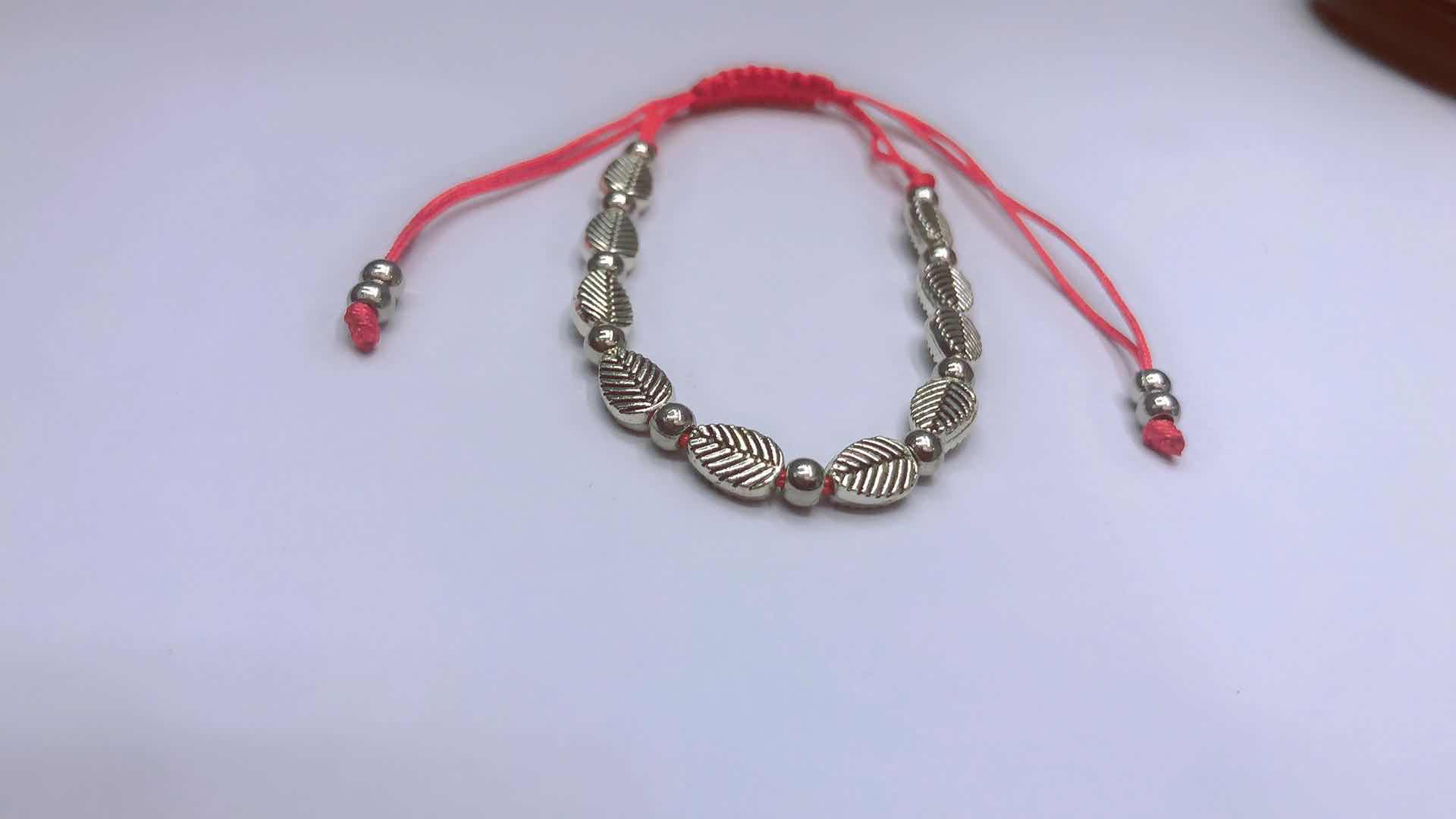 The No. 72 jade thread runs through the middle and ends in a flat knot bracelet. It features alloy leaves and two ccb tails