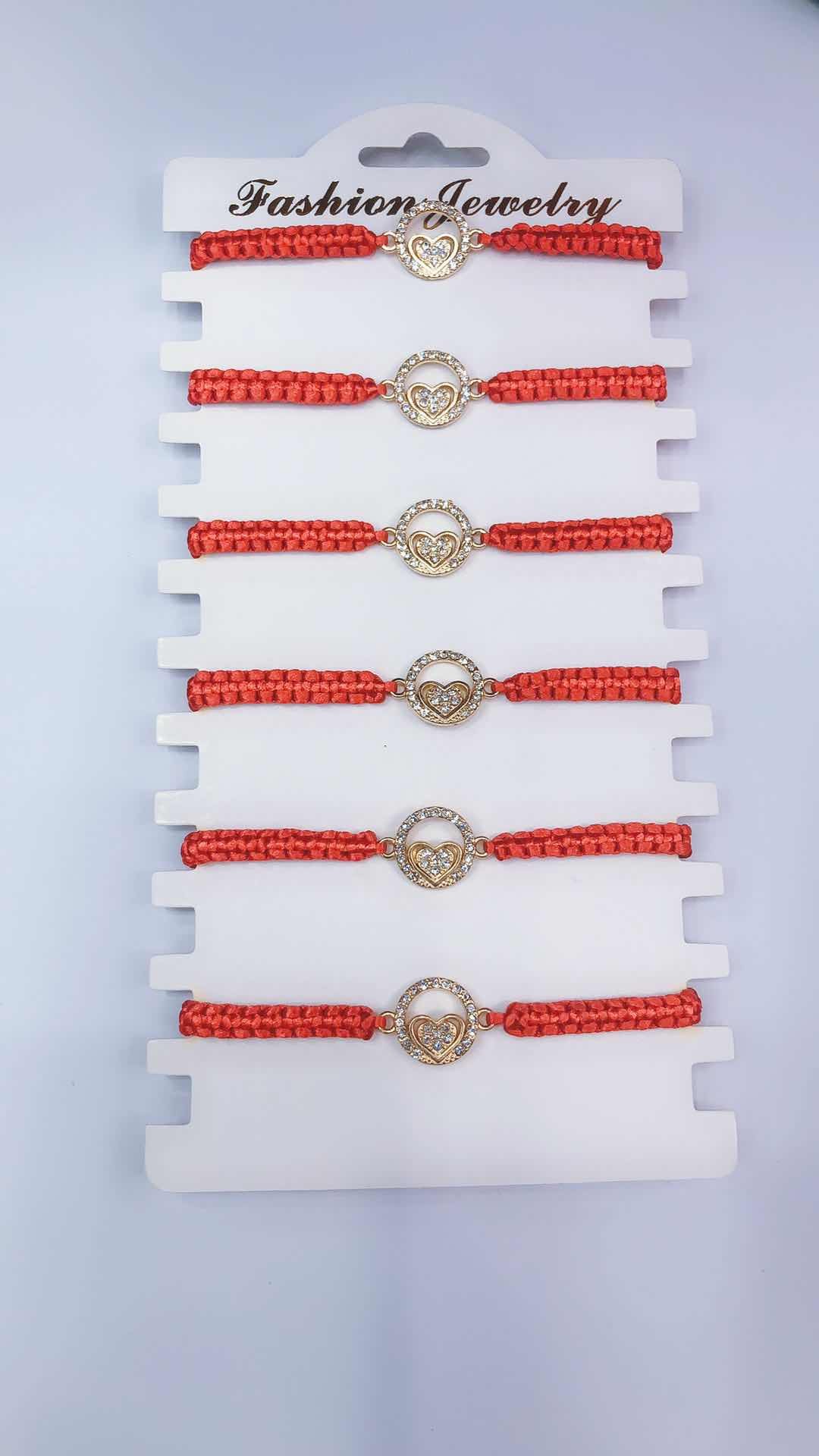 The plain knot woven bracelet is made of alloy with a circular shape and a heart in the middle detail image 1