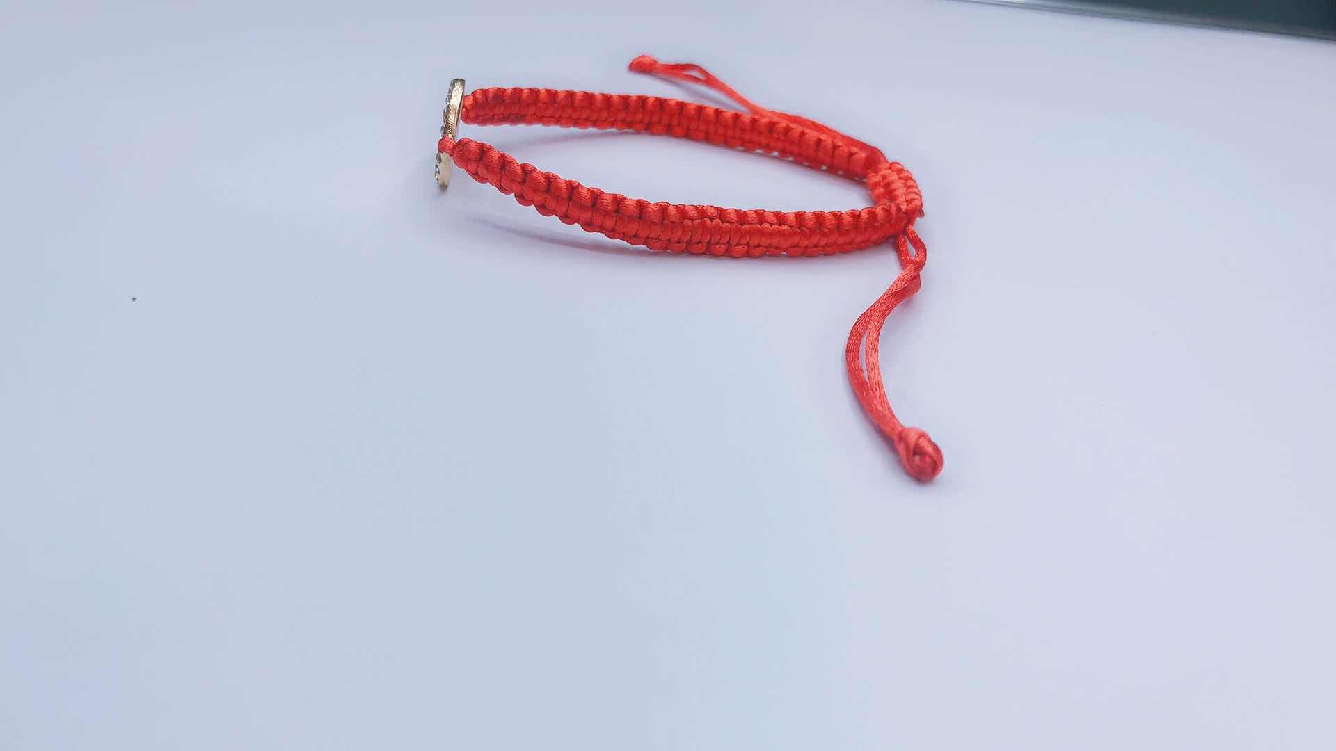 The plain knot woven bracelet is made of alloy with a circular shape and a heart in the middle detail image 5