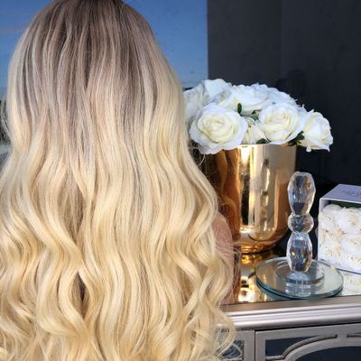 The new wig is made of chemical fiber for European and American women. It features golden yellow mid-parted long curls and slightly curly long straight hair Item Picture