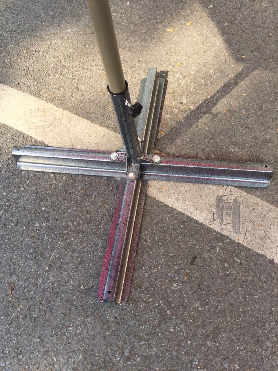 A cross-shaped base with an outdoor umbrella