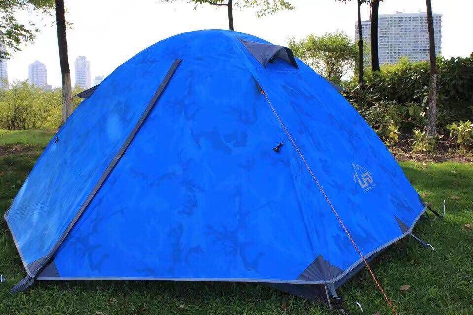 Two people set up a tent with aluminum poles