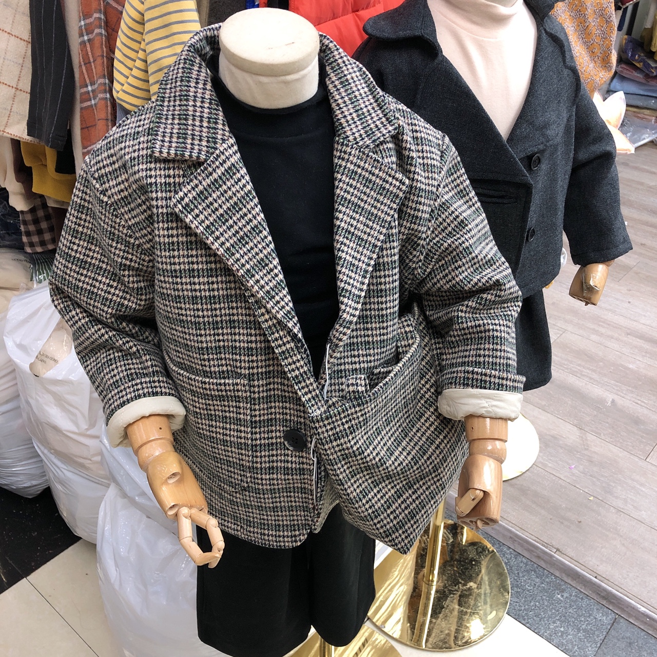 A checked coat with a purse thumbnail