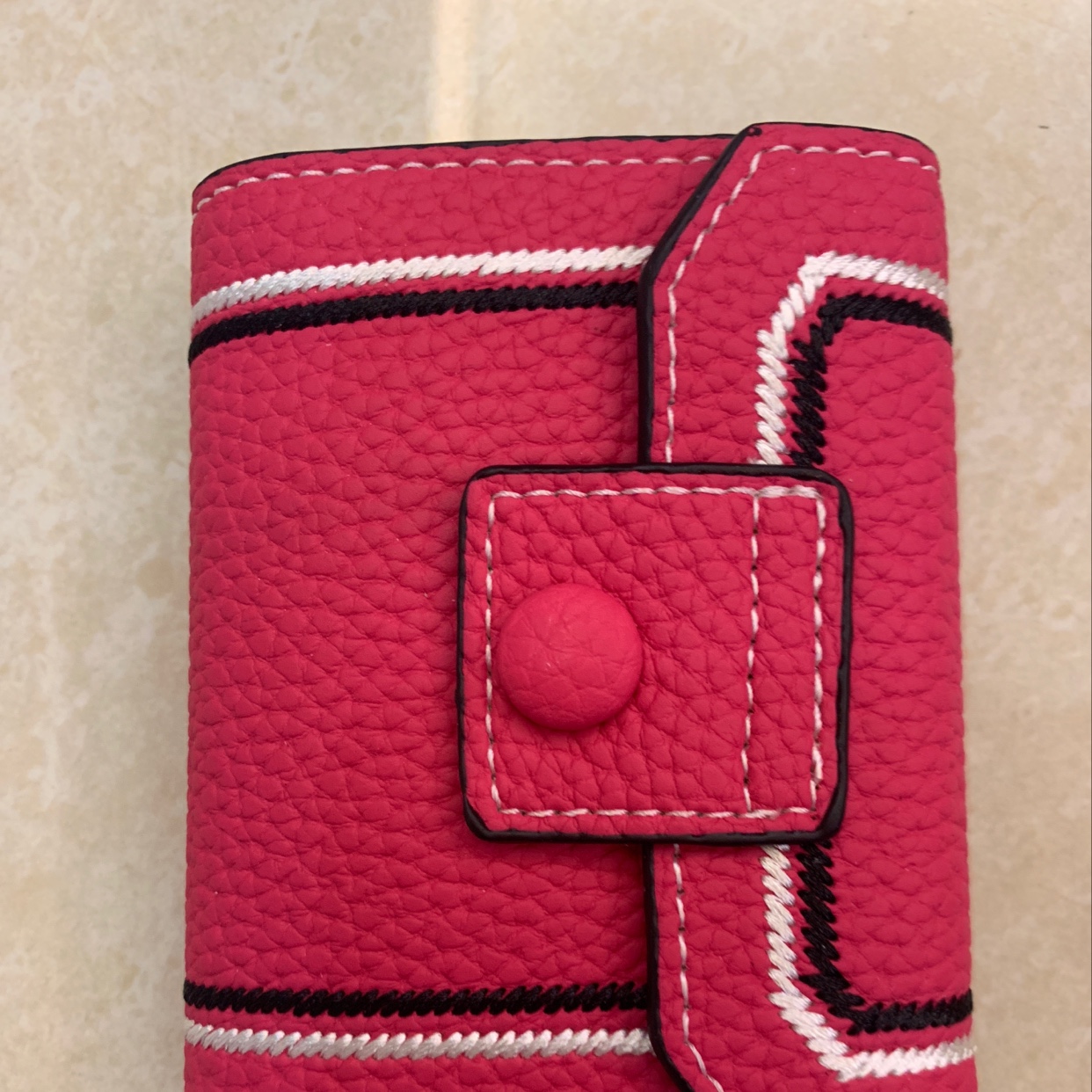 The new card bag is in plum red