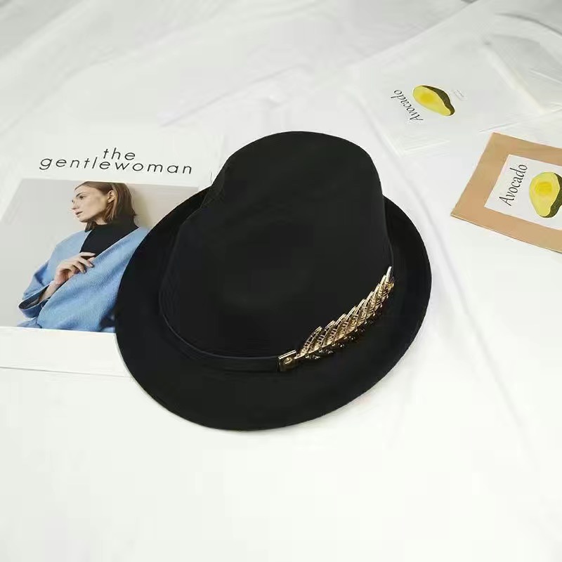 A woolen top hat decorated with metal leaves