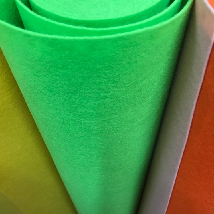 The felt fabric is green with grass