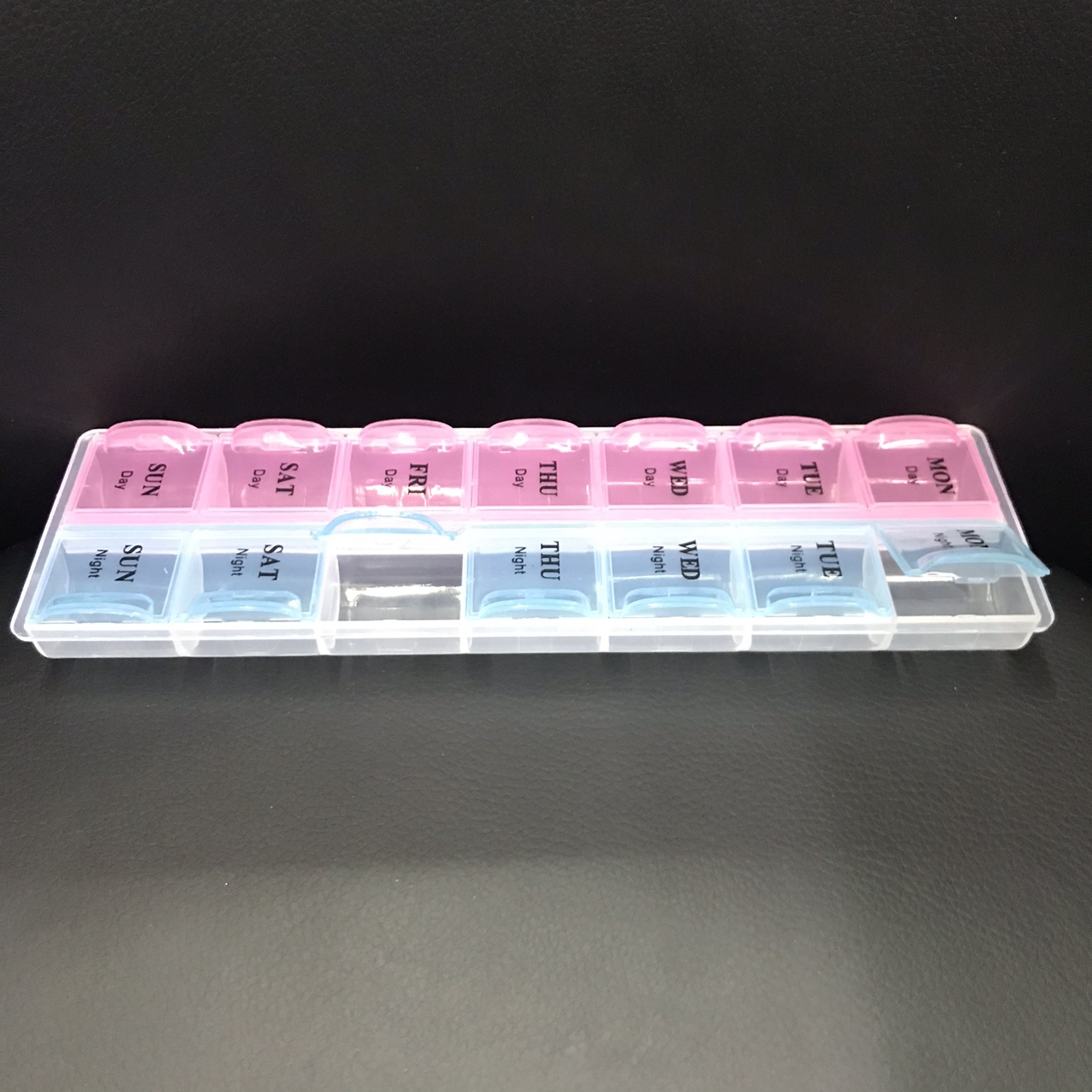 Two rows of plastic medicine containers thumbnail
