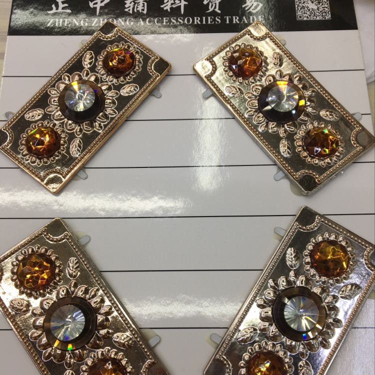 Several different styles of plastic buckle diamond jewelry neatly arranged on a black velvet cloth