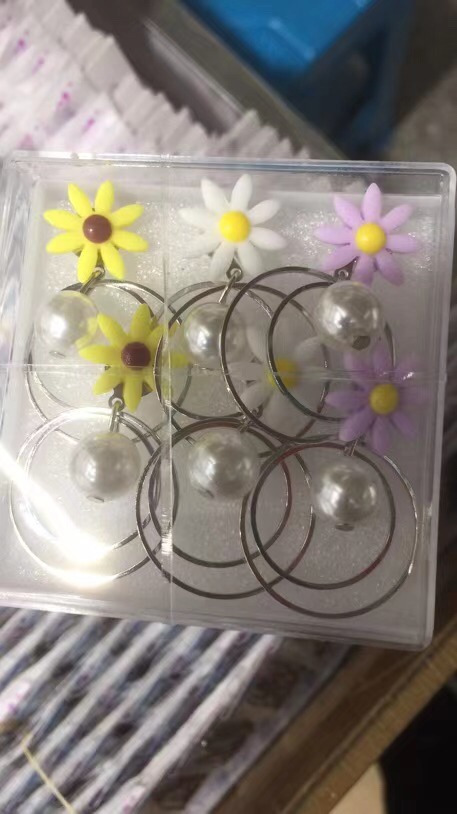 Tapered flowers hanging pearls in large circles thumbnail