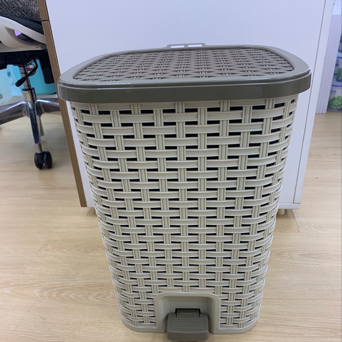 Step on the trash can with a large foot. full figure
