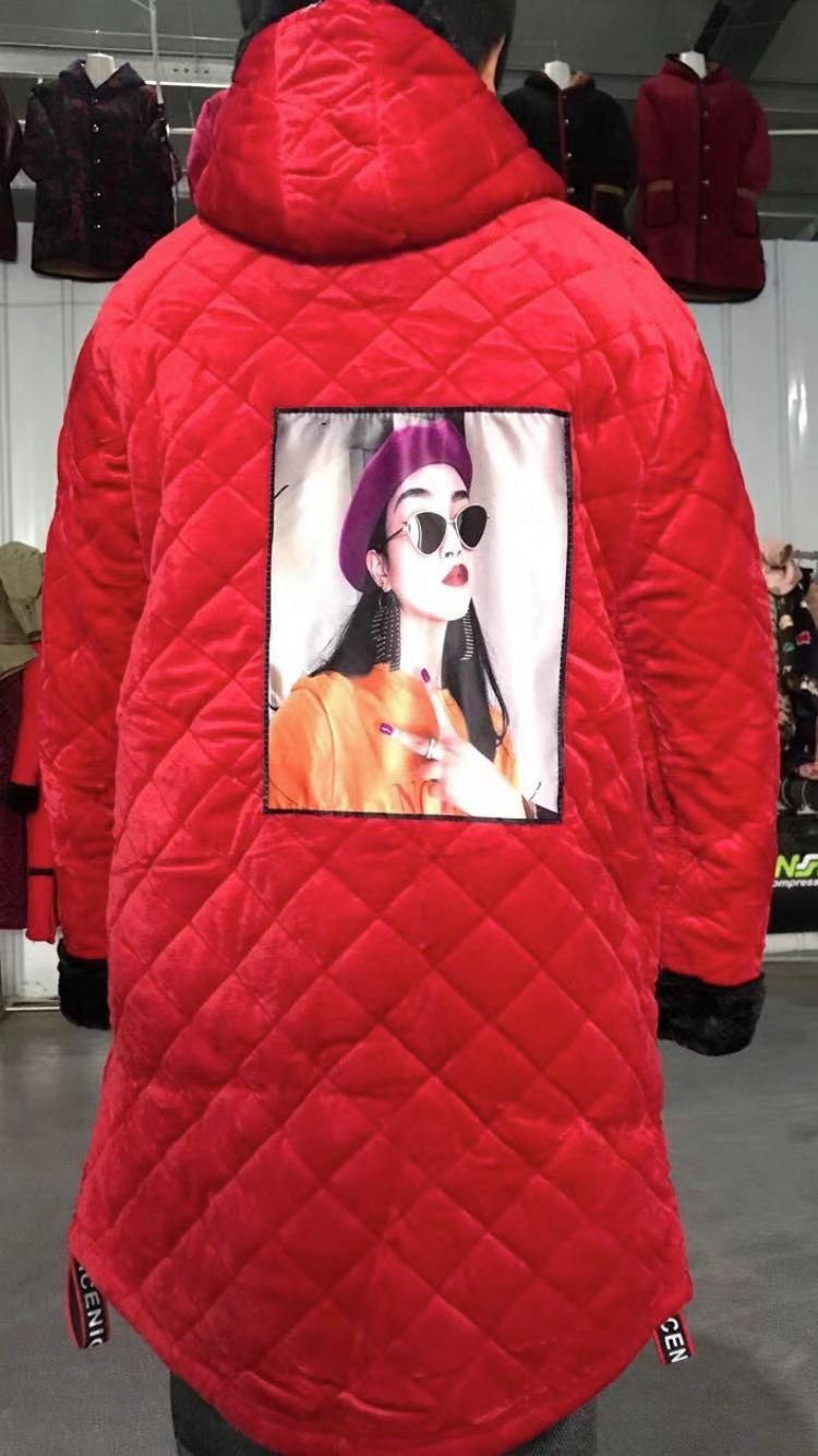 The lady is wearing a bright red cotton coat