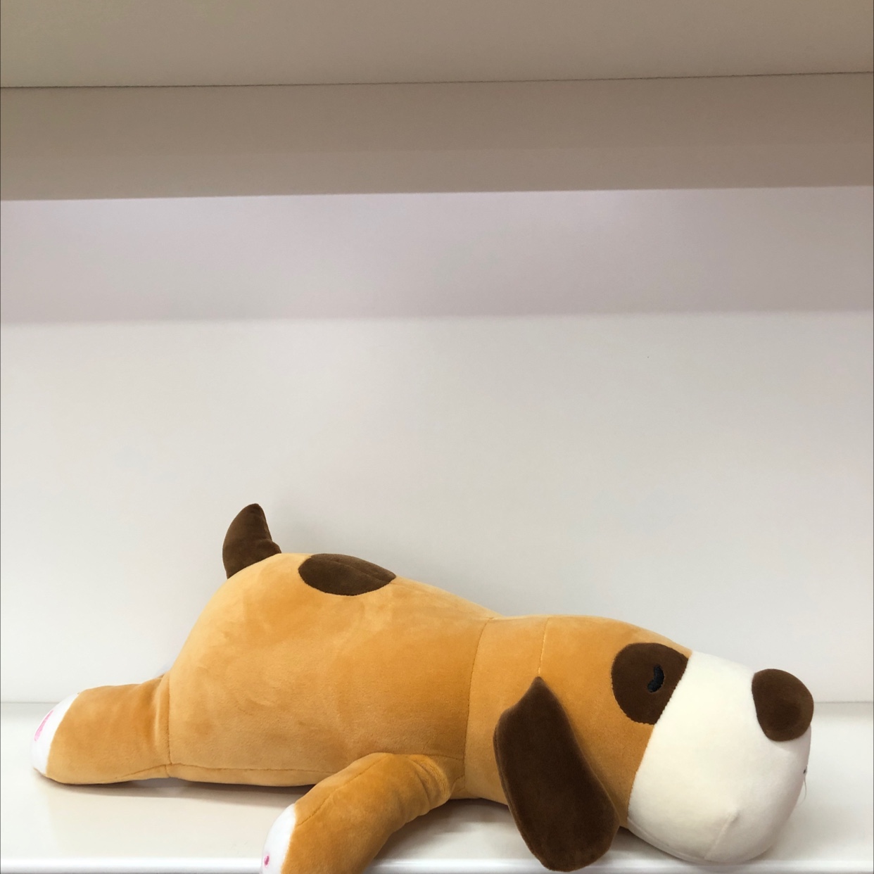 Yellow crouching dog figurine