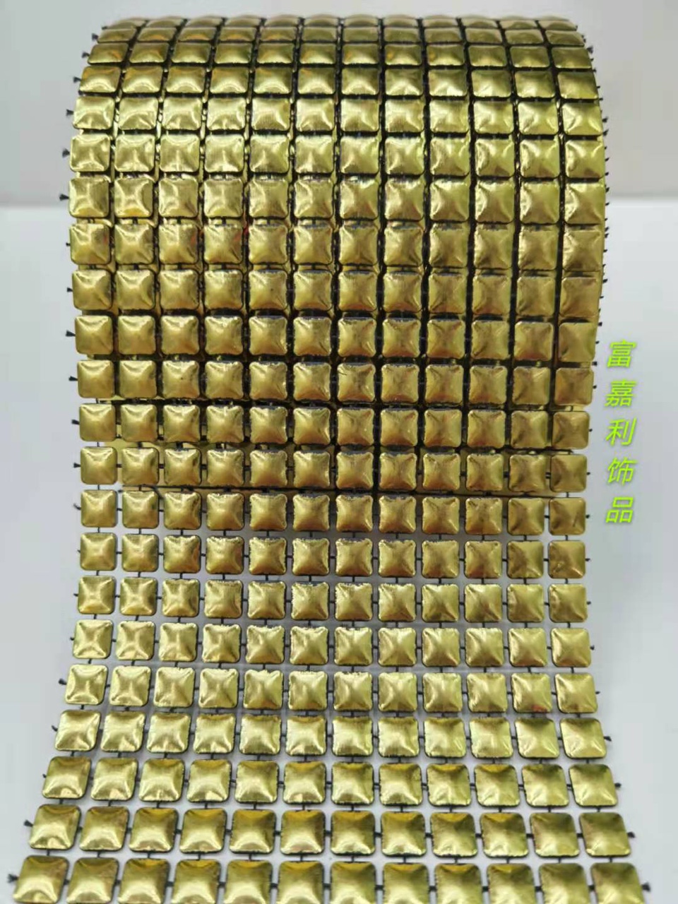 12 rows of small square black backgrounds with gold foil