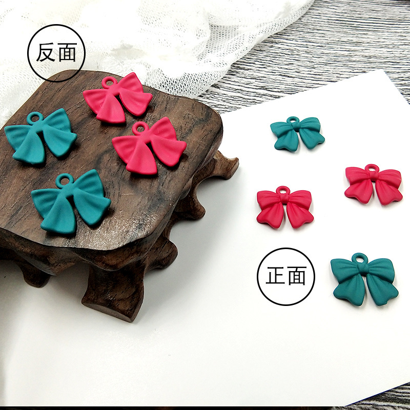 Factory direct sales of alloy baked paint bow tie pendant Korean-style, niche, simple and versatile earrings and stud earrings details Picture
