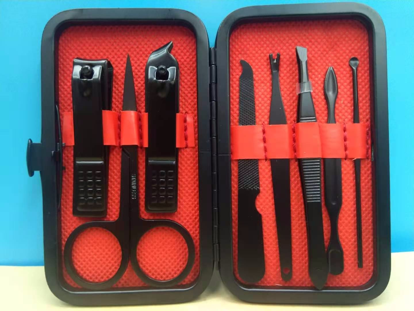 Black 8-piece set of nail clippers, eyebrow clippers, ear scoops and tweezers detail image 2