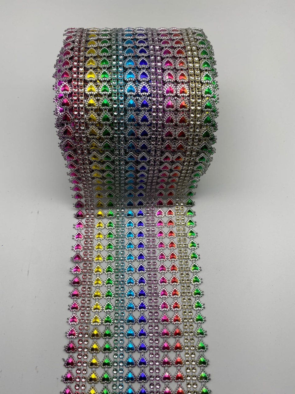 Eight rows of small hearts with reverse diamonds, silver background with seven colors