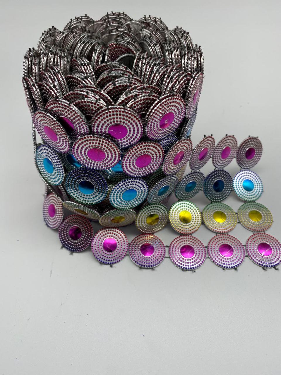 Four rows of large circles, silver background with seven colors of embossing