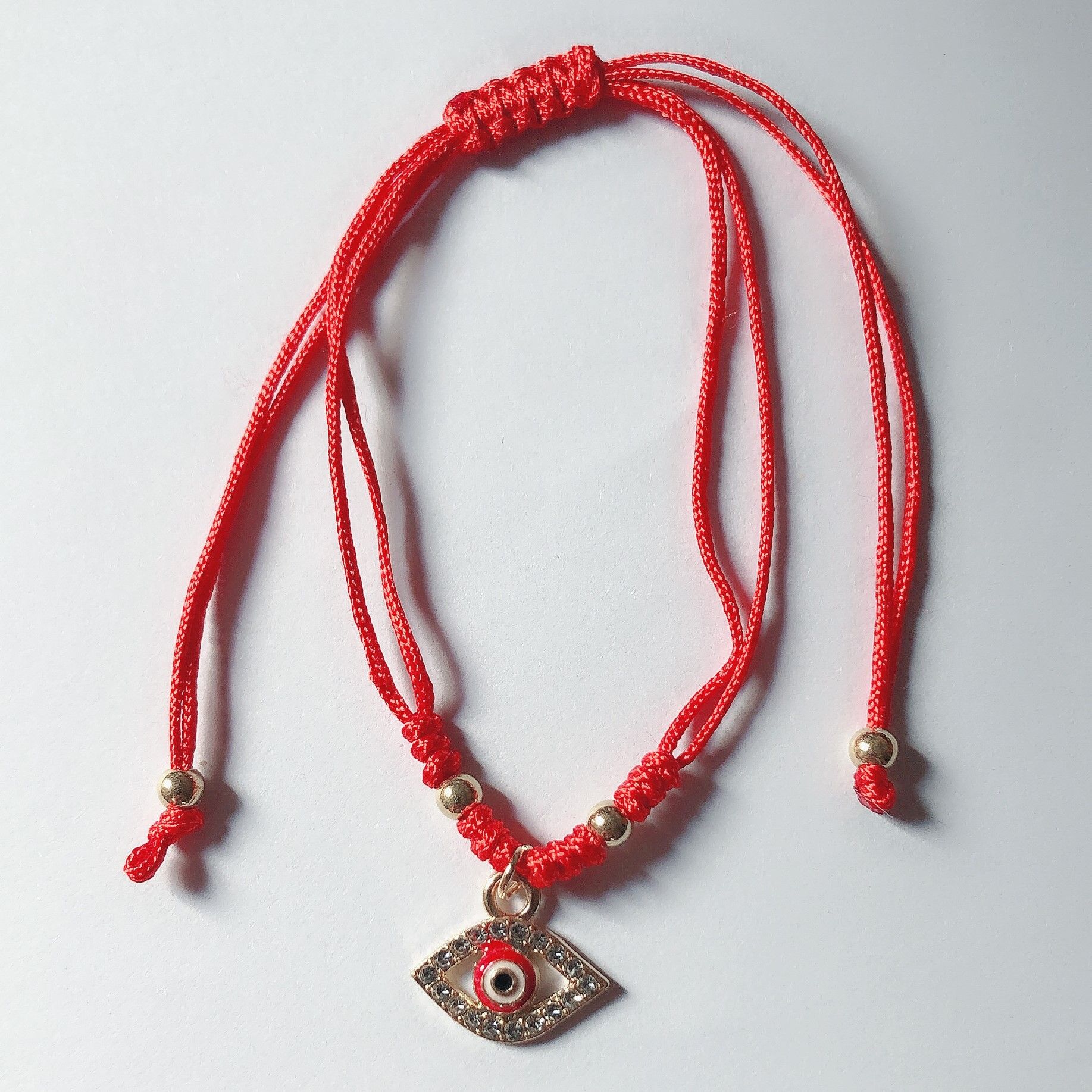 Braided bracelet with snake incorporating gold middle drops of oil for eyes