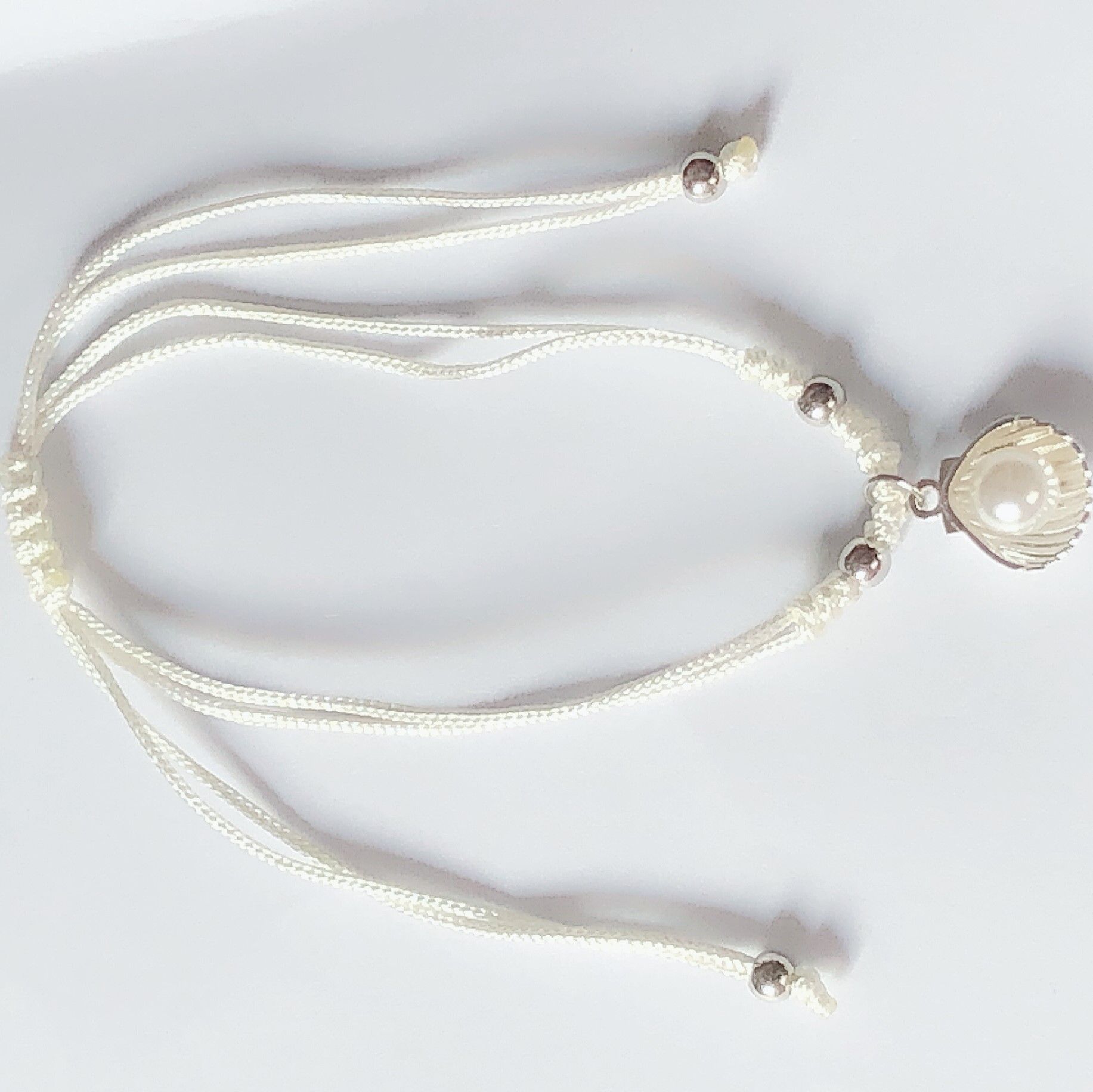 Braided bracelet with snake incorporating gold and pearl on top thumbnail
