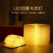 Custom creative page turning LED four-color bedside light USB rechargeable folding book light decorative portable book light