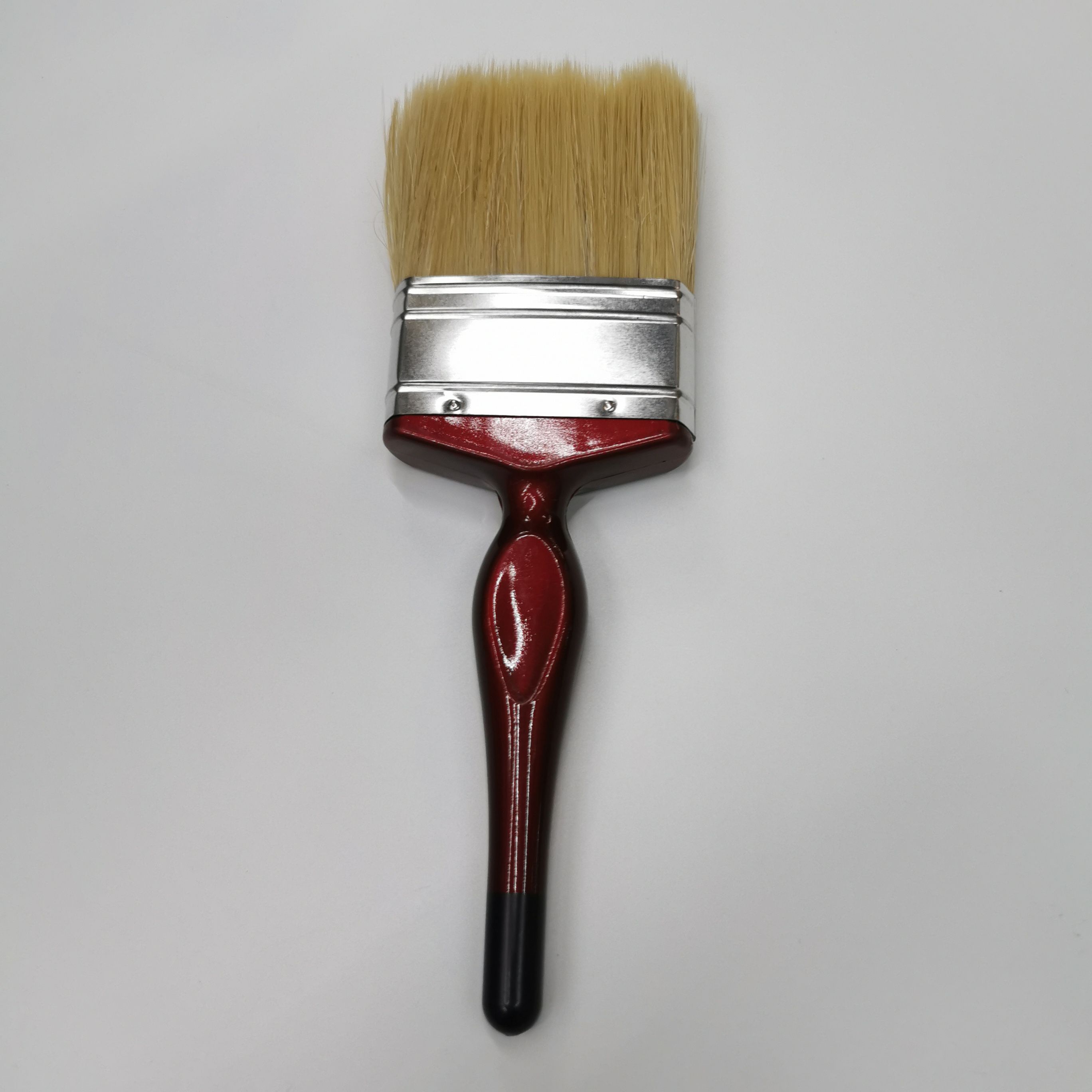 A popular and practical wall-painting tool, a red plastic-handled white bristle brush