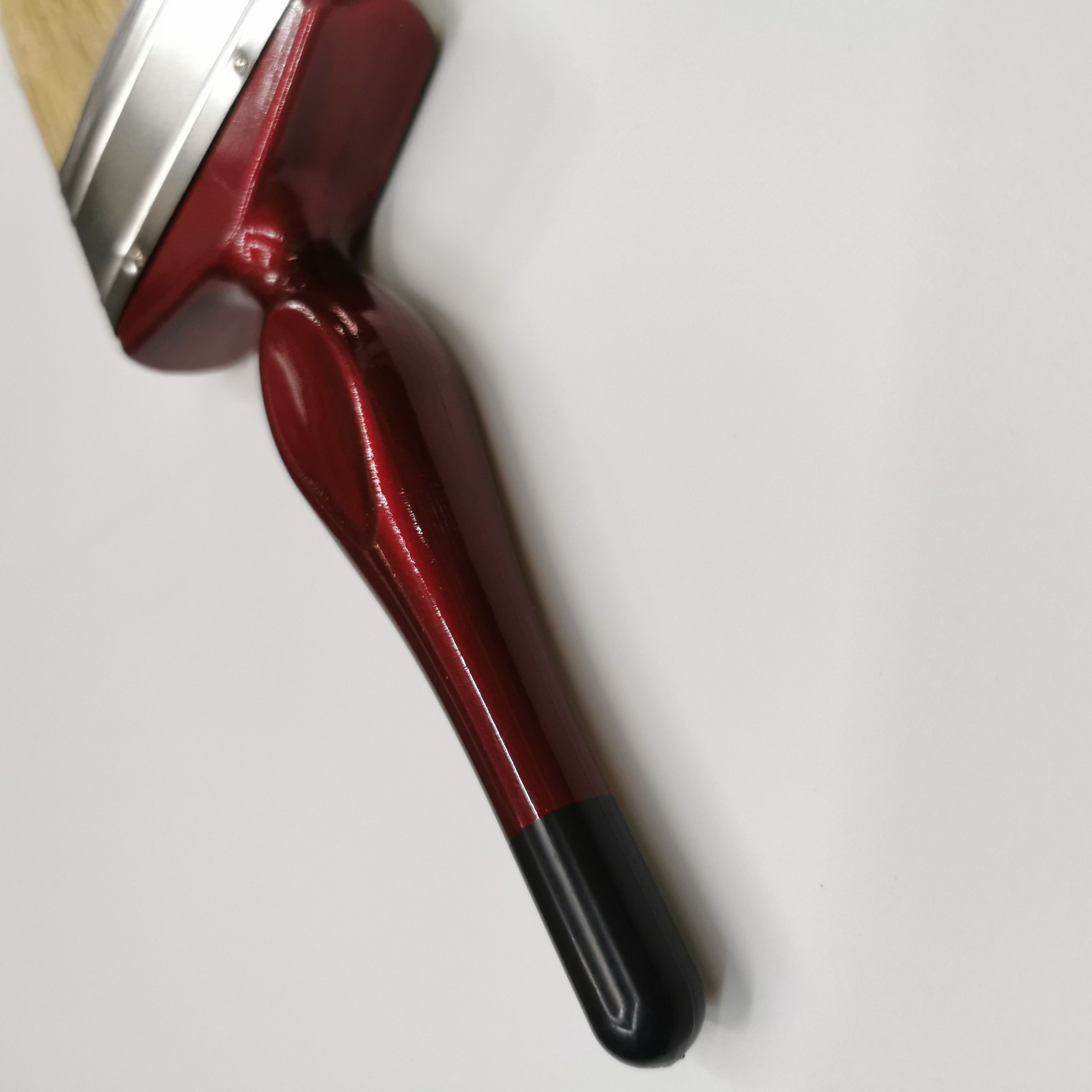 A popular and practical wall-painting tool, a red plastic-handled white bristle brush details Picture