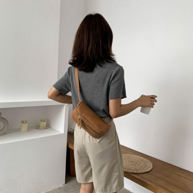 Woman with a chest bag, a waist bag and a crossbody bag