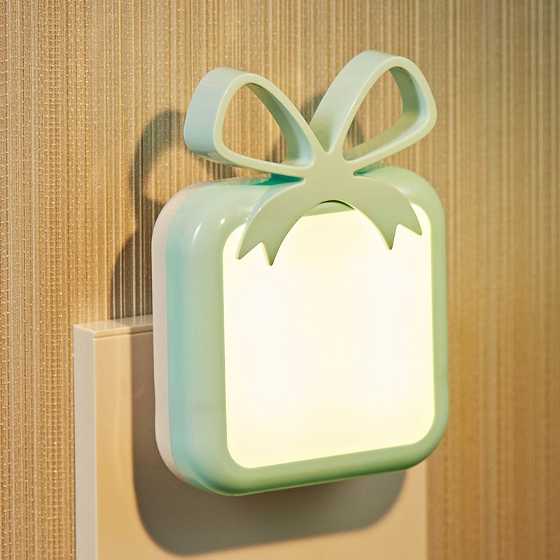 The bow-shaped cute night light is green