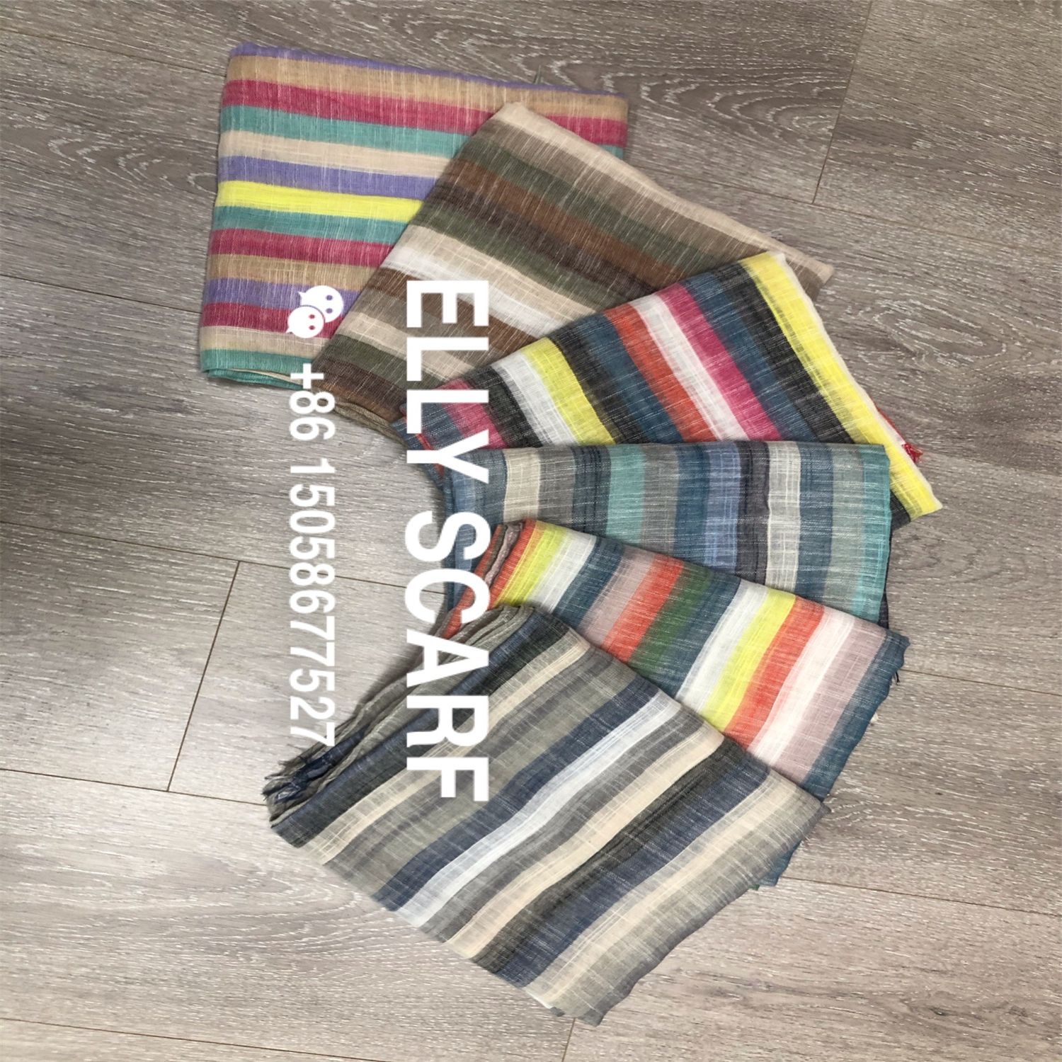 A vertical striped rainbow-colored scarf made of linen and cotton details Picture