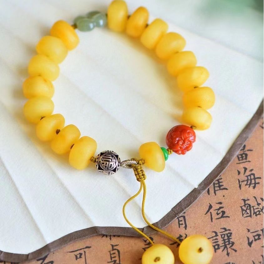 天然蜜蜡多宝手链 颗粒饱满 色泽均匀  尺寸12mm 手工编织