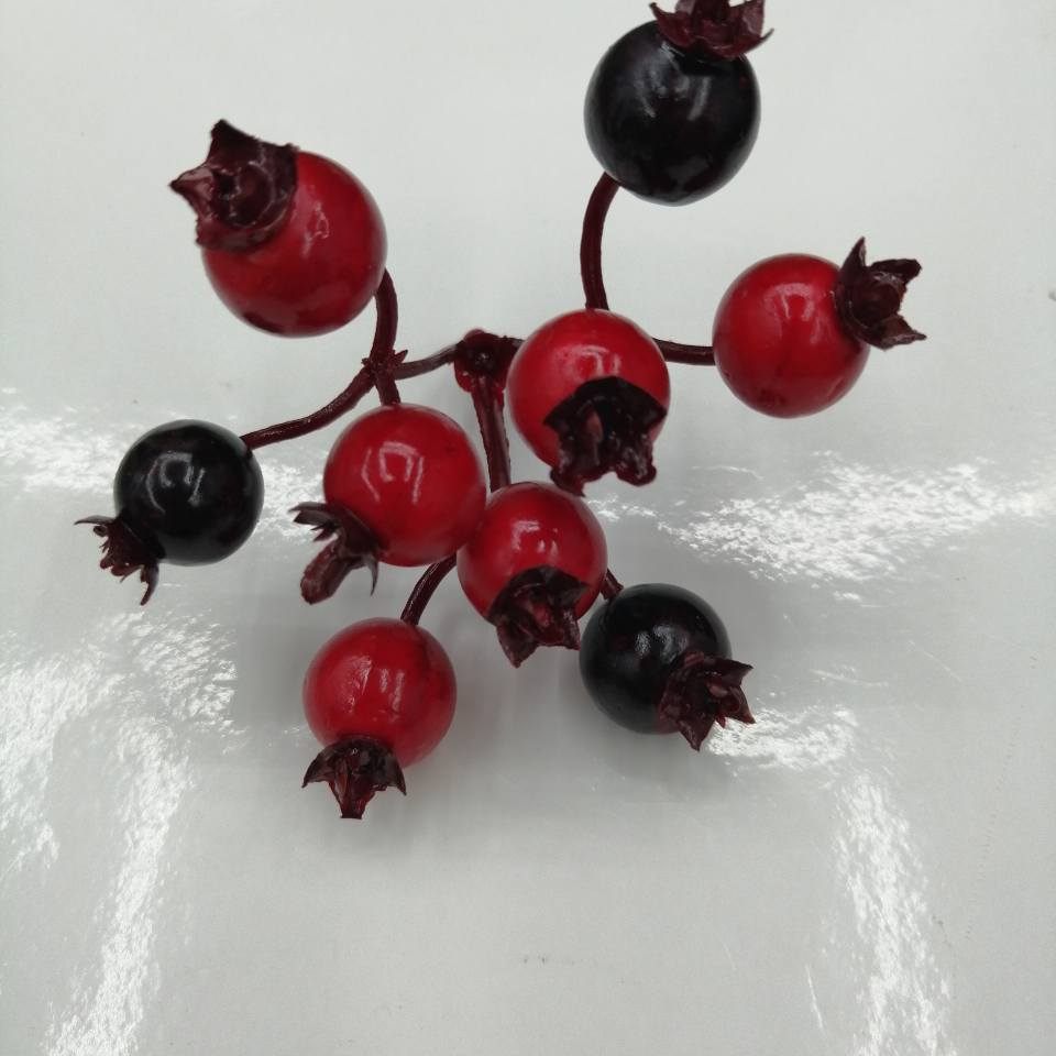 A red and black three-pronged nine-headed fruit with a top