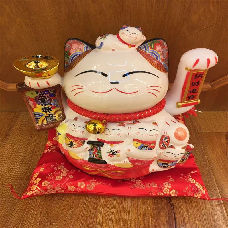 South Tai money into the shaking hand ornaments open gift shop shop cash register shaking cat