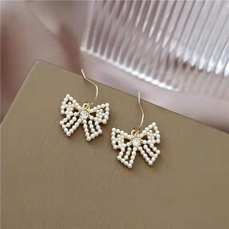 Cute bow pearl inlaid lady's cold and simple style earrings detail image 2