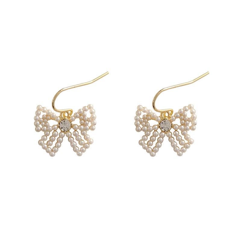 Cute bow pearl inlaid lady's cold and simple style earrings