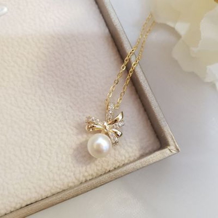 European and American fashion bow alloy inlaid acrylic pearl pendant ladies' cold necklace detail image 1