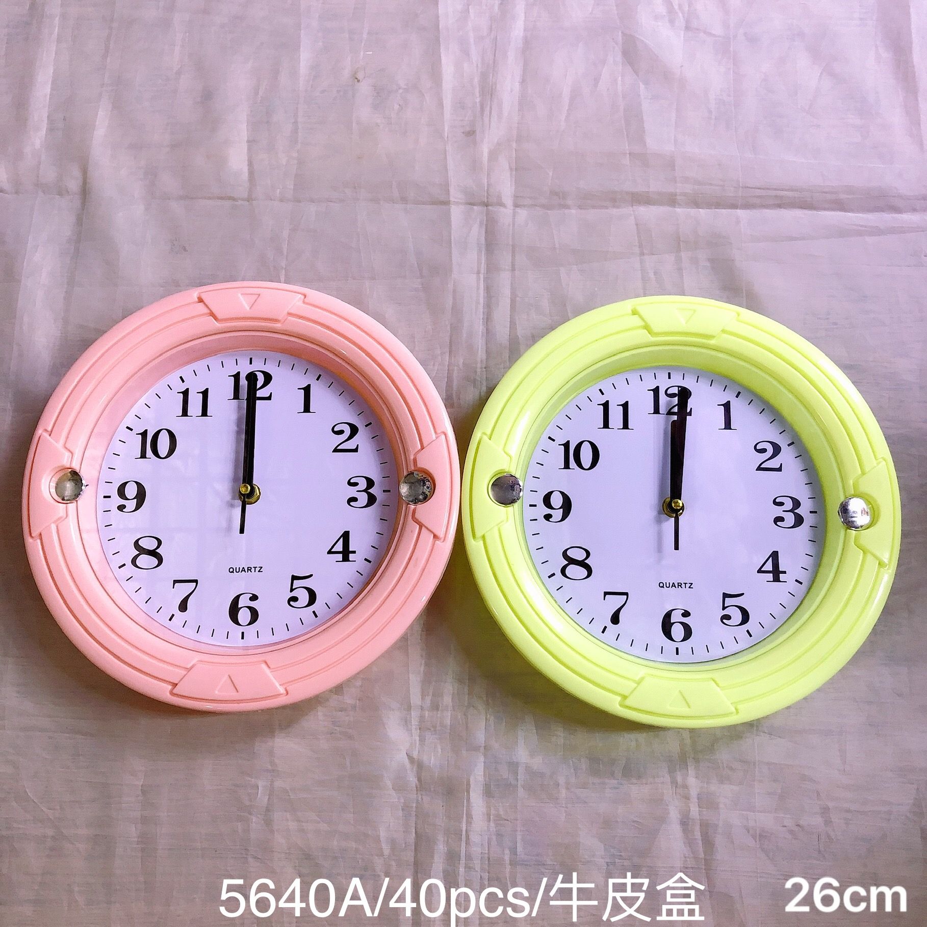 The foreign trade color series wall clock can be printed with LOGO. It is a round candy-colored household wall watch, measuring 26cm