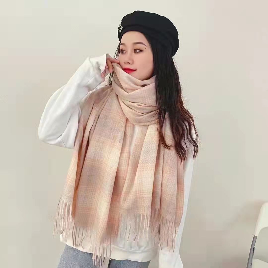 Woman wearing a long winter scarf in city setting