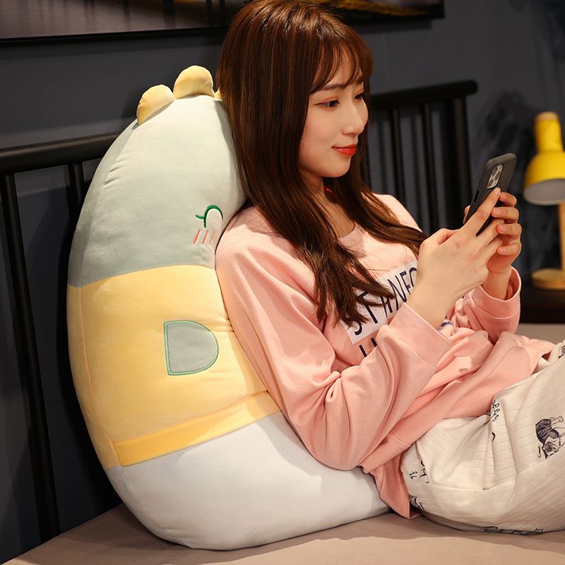 The cute little dinosaur pillow from Miaokefang with legs clamped on the bed in the bedroom Application Scenario