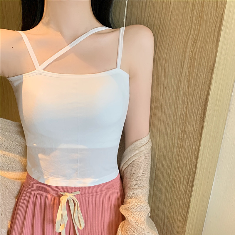 This summer short top with a white halter top and a chest cushion is designed to create a unique and trendy female look. It's a sweet and spicy little vest worn outside