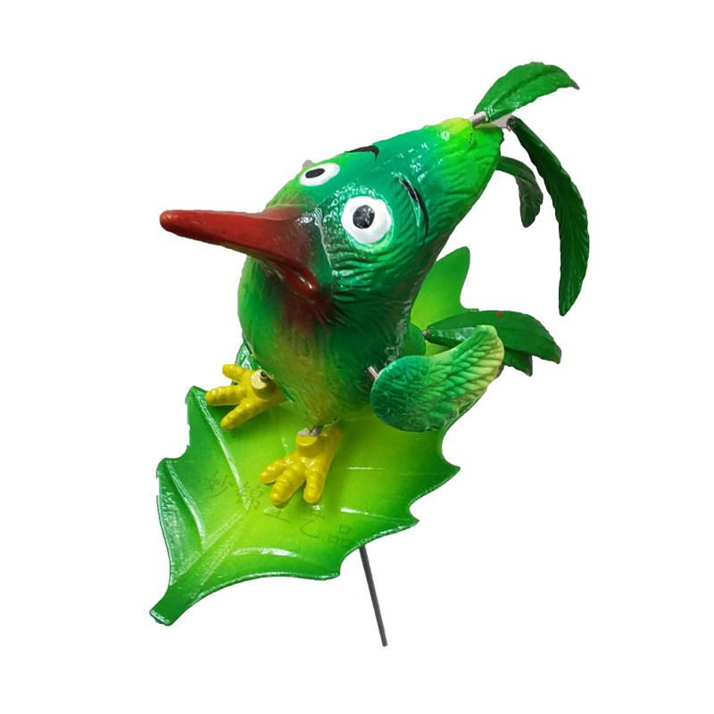 Bird garden decor placed among small potted plants on a balcony