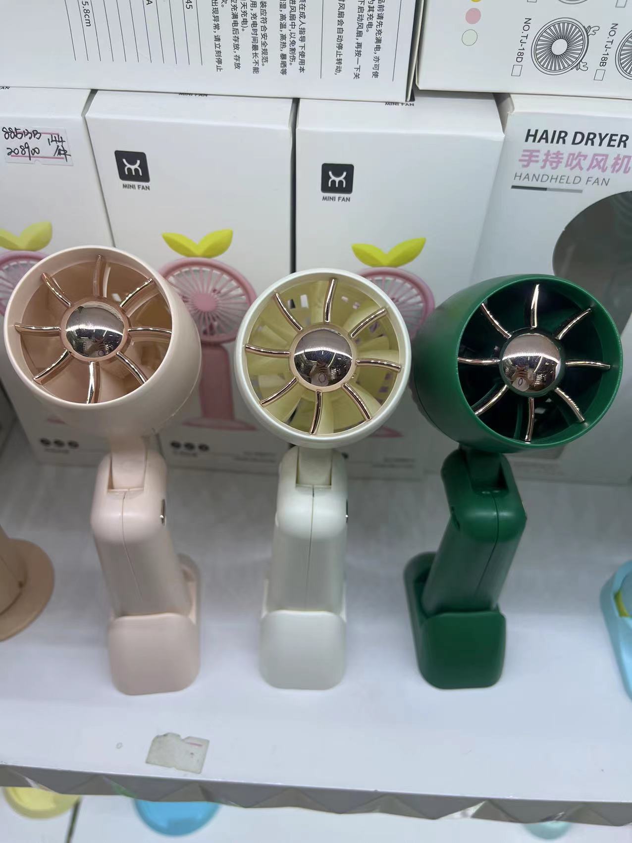 The KD-179 foldable hair dryer fan comes in three colors: white, green and pink. It is a foldable handheld fan that is convenient to carry pic 1
