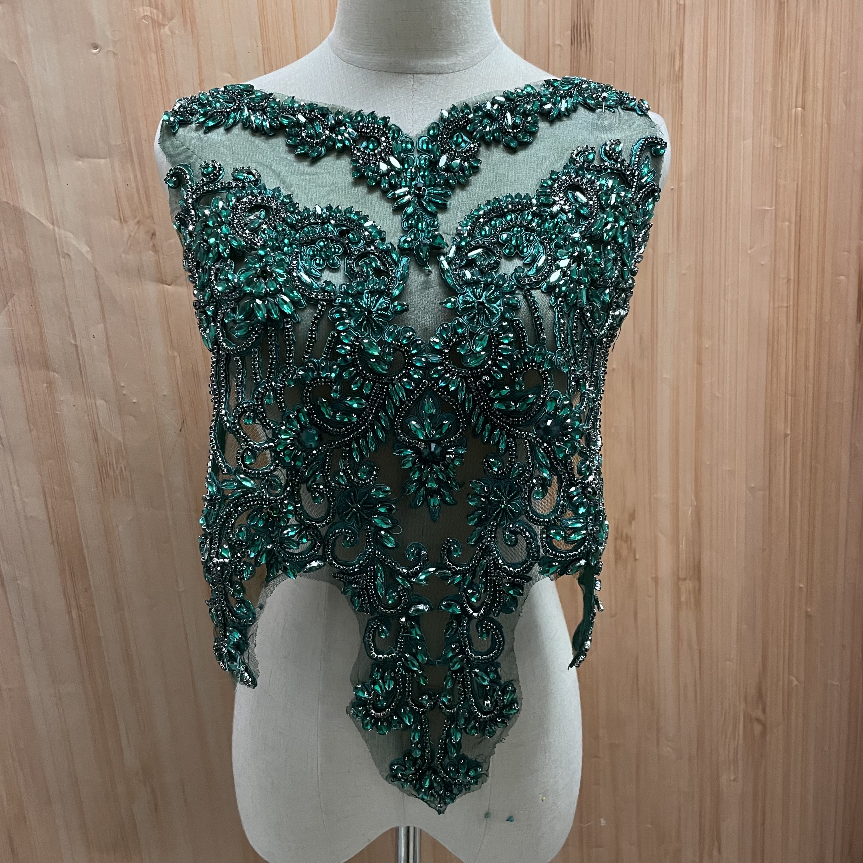 Hand-stitched beaded wedding dresses and evening gowns are decorated with lace decals