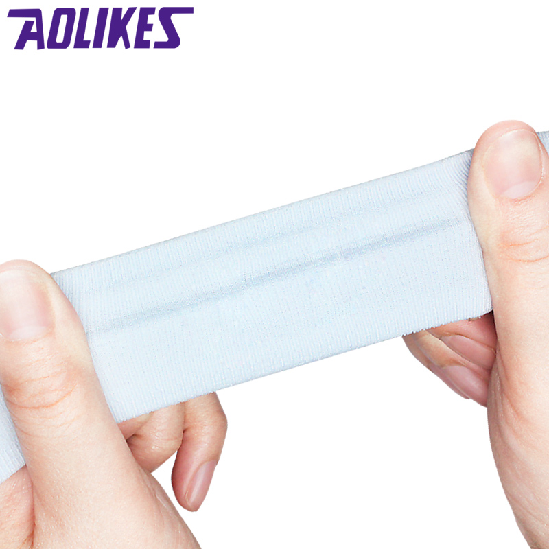 Athlete using the sweat-wicking headband during intense workout