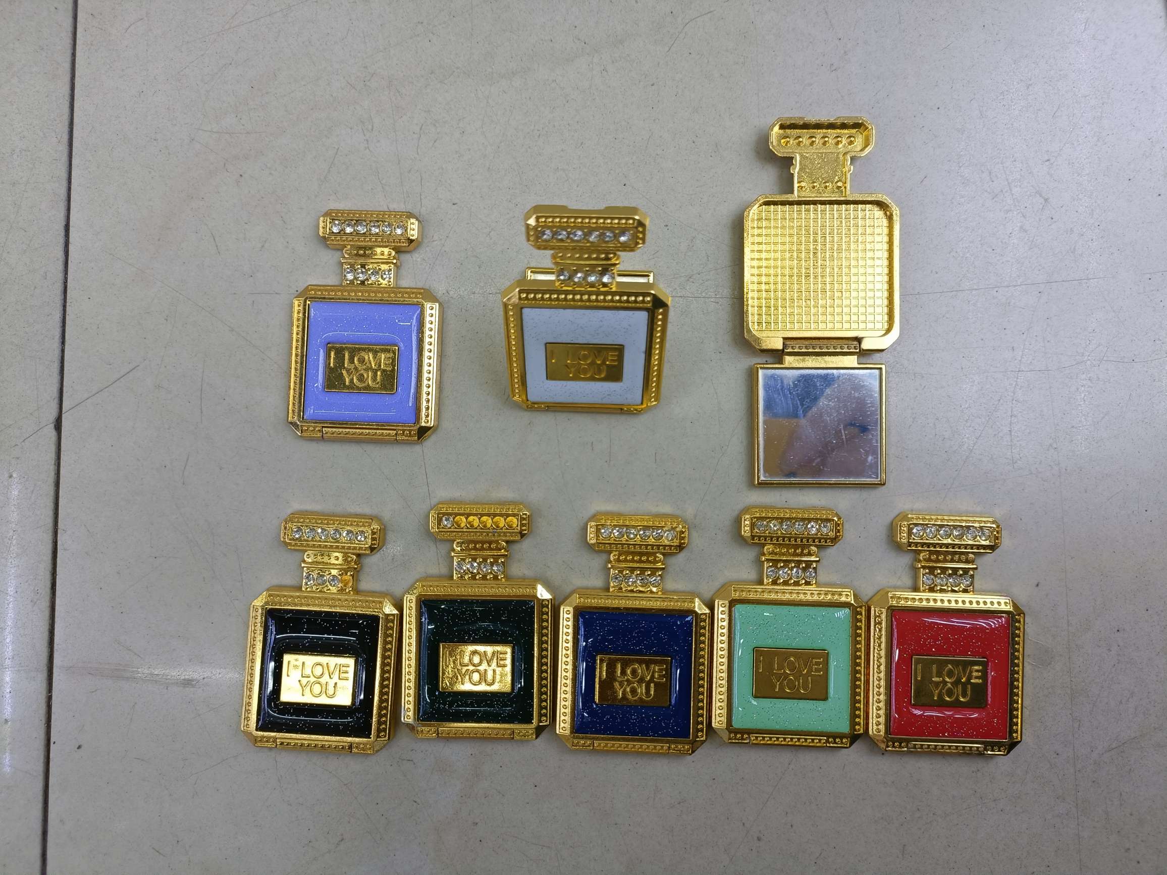 Perfume bottle phone holder with mirror
