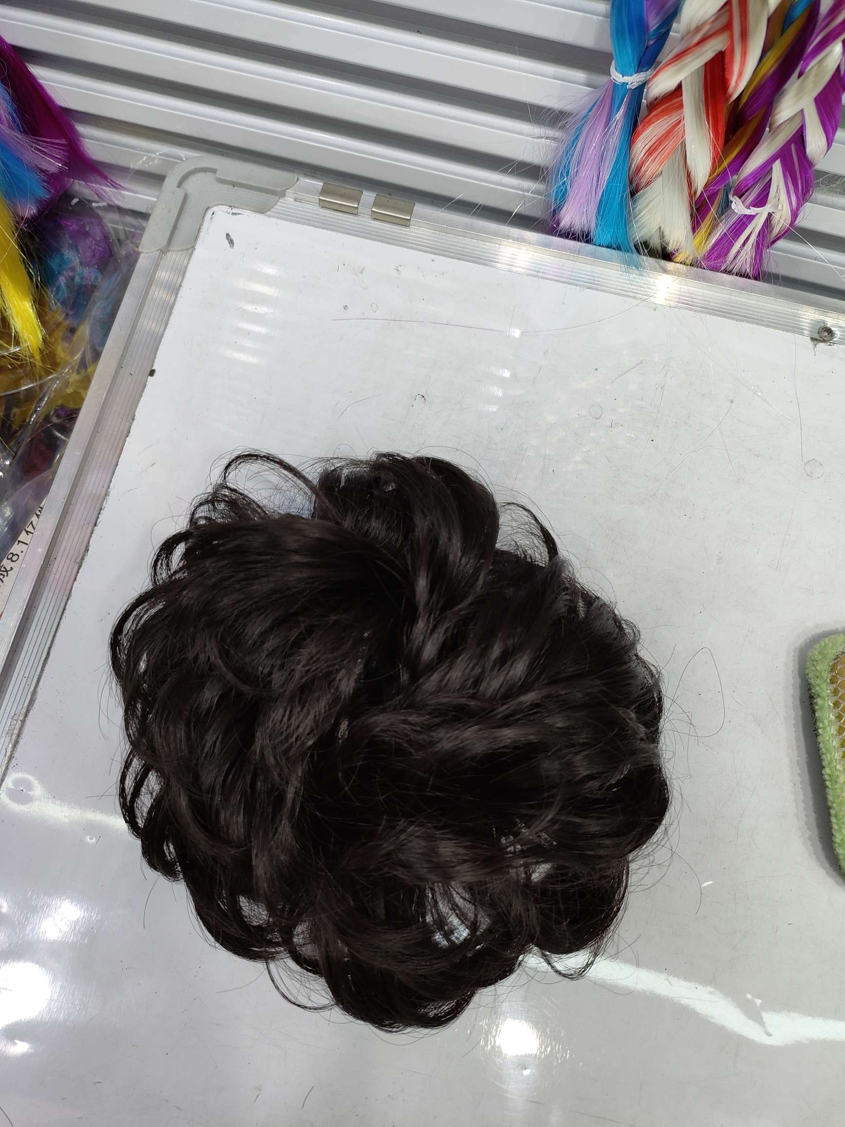 A natural, fluffy and long beard wig for women with a laid-back hair band and a flower bud bun hairstyle