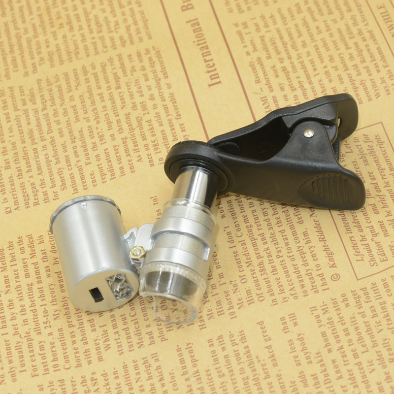 Yiwu Jinghui Factory Direct sales: Black 60x mobile phone holder with banknote detector LED light microscope magnifying glass 9882W1 Application Scenario