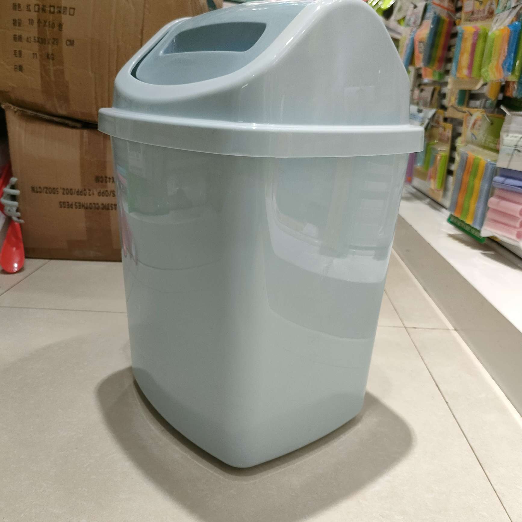 The bathroom trash can has a narrow lid. The toilet flap has a narrow rectangular slit with a lid. The living room flap is a household type details Picture