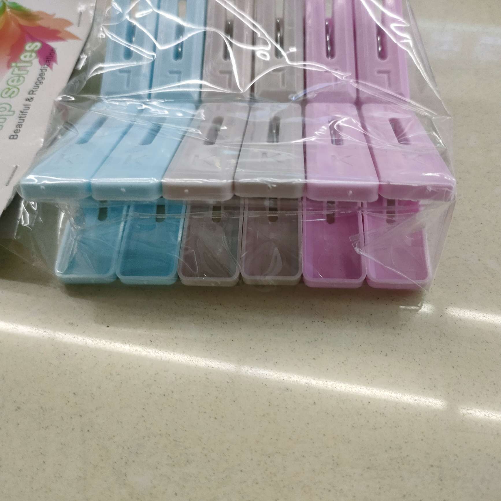 A pack of 12 plastic coat clips, sock clips, bright-colored windbreaker clips and plastic drying clips details Picture